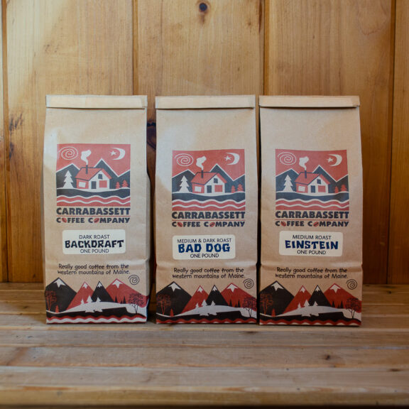 A photograph of three Carrabassett Coffee one-pound kraft bags for local pickup in the entryway of the Kingfield roastery.